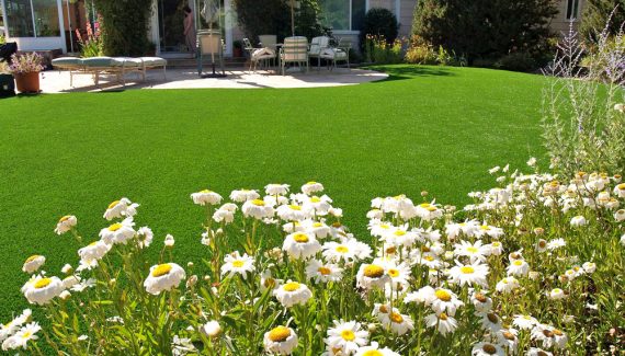 Artificial lawn installed in a backyard with a beautiful landscape